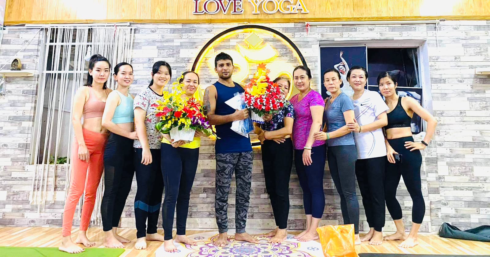 Ved Yoga Shala students celebrating with flowers